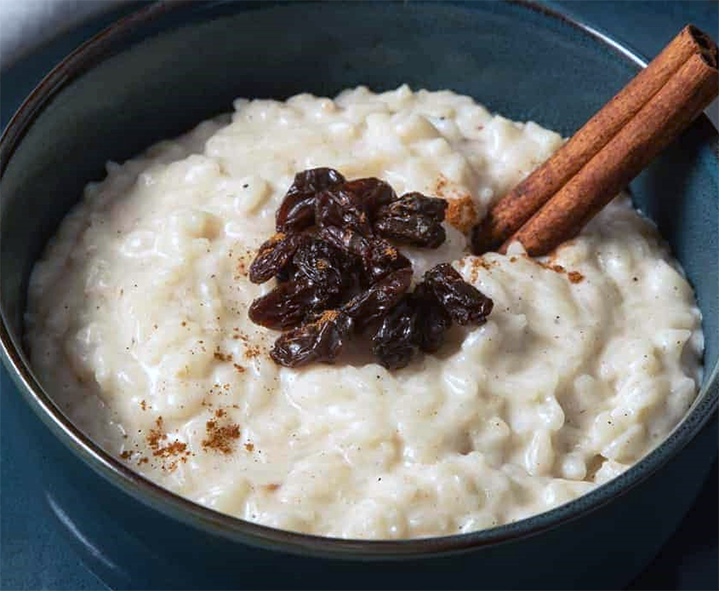 rich rice pudding garnished with a cinnamon stick