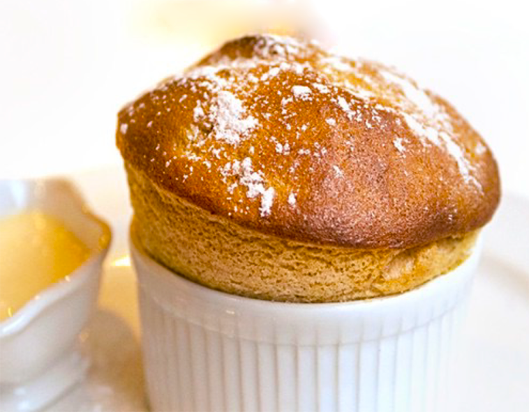 Prune and Armagnac Soufflé with Armagnac Custard in a ramekin