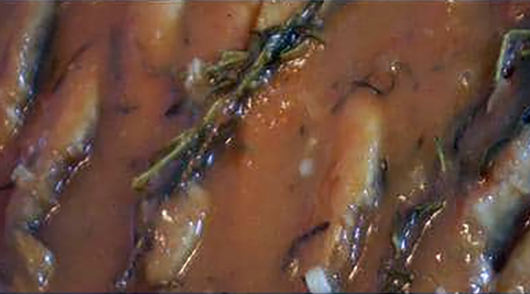 red mullet in a savoro sauce cooking in a frying pan