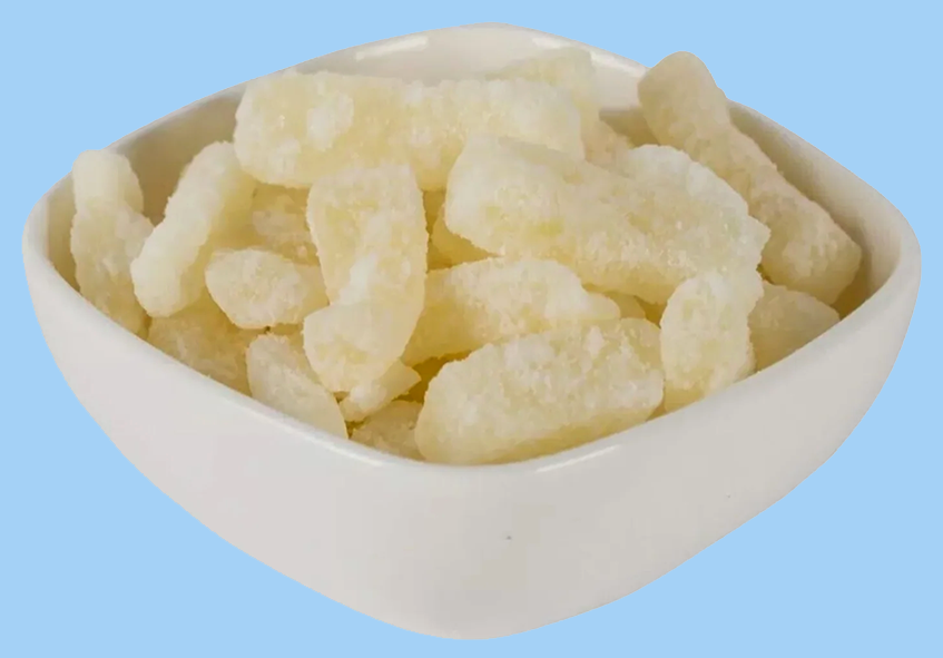 cut-up pieces of candied wintermelon, puhul dosi, in a white bowl against a powder blue background