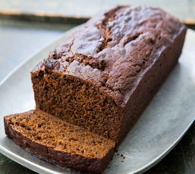 pumpkin gingerbread loaf with one slice cut off on a plate