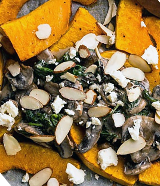 roast pumpkin wedges with mushrooms on a baking tray
