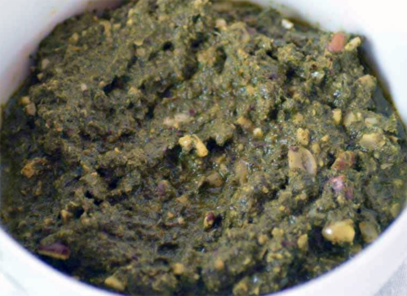 Ravitoto sy Voanjo Malagasy stew of cassava leaves with peanuts in a bowl