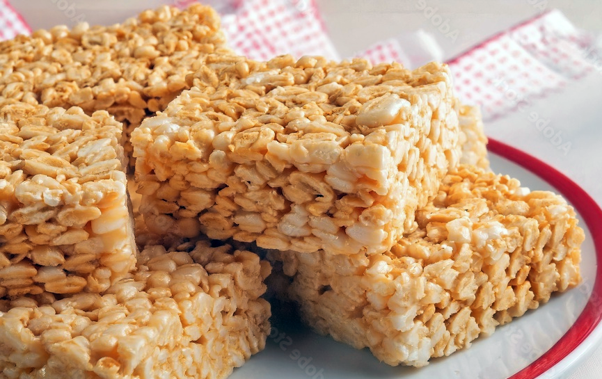 squares of rice krispies bound with marshmallows and butter coloured orange for halloween