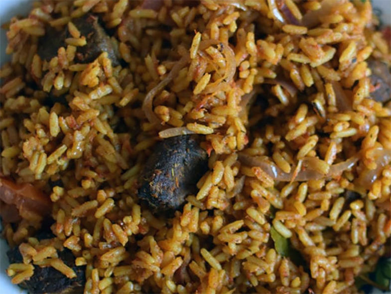 Niger jollof rice with beef and chicken in a bowl