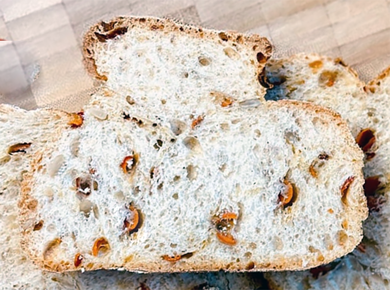 slice of rose hip nut bread on a chopping board