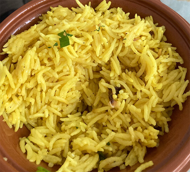 golden safflower rice in an earthenware bowl