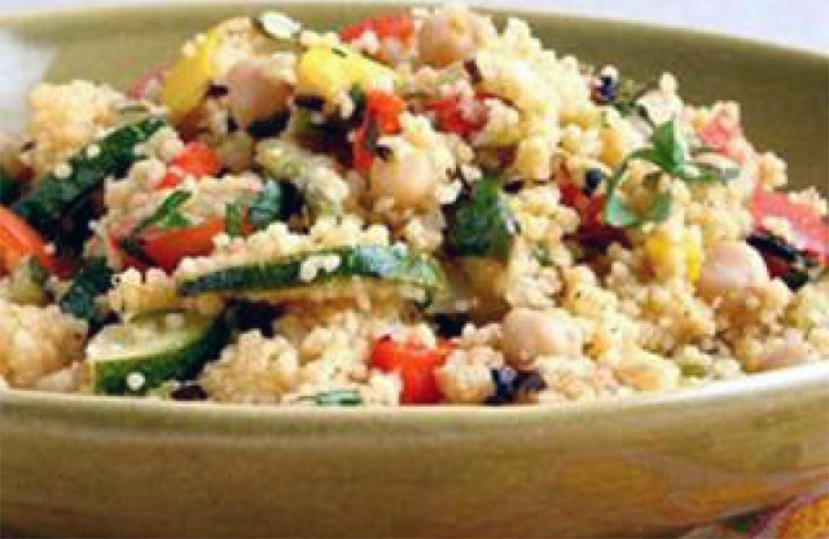 Salat tangiers of carrots, green beans, courgettes, onions, almonds and currants blended with couscous and served in a bowl