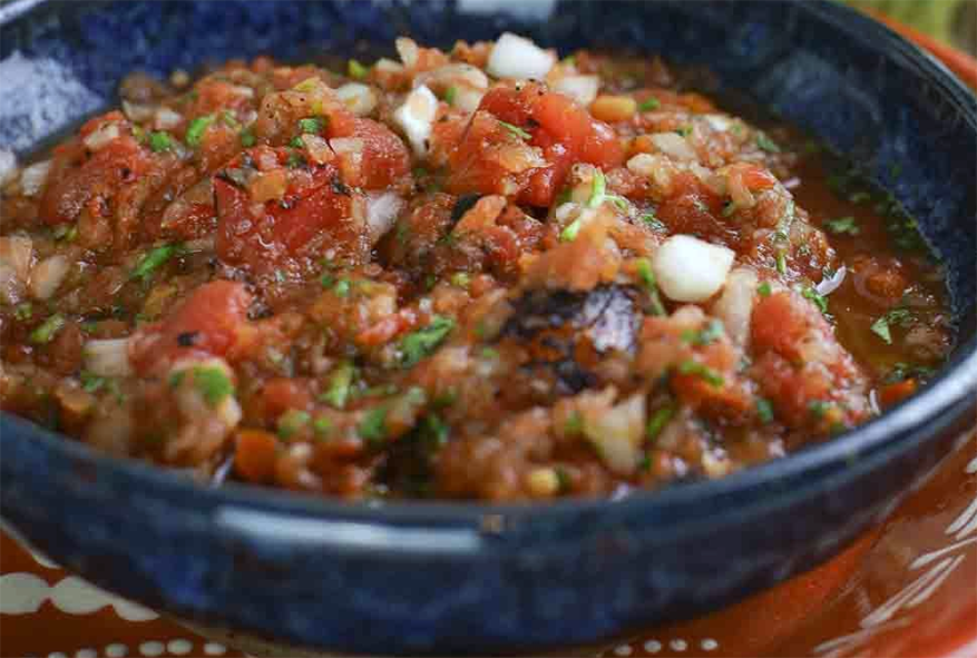 chopped red tomatillo salsa in a bowl