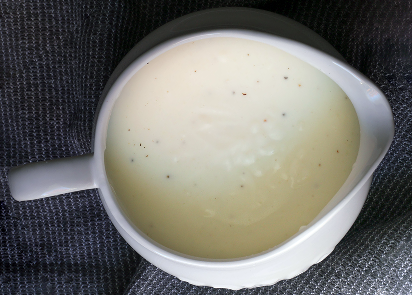 white coconut sauce in a sauce boat