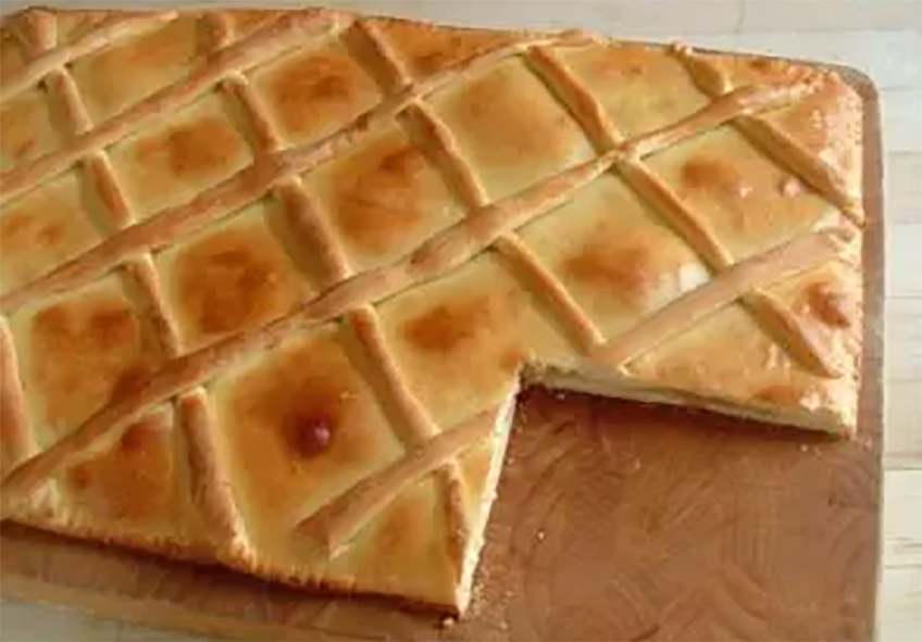 Salvadorean pineapple semita on a chopping board with a square removed from one end