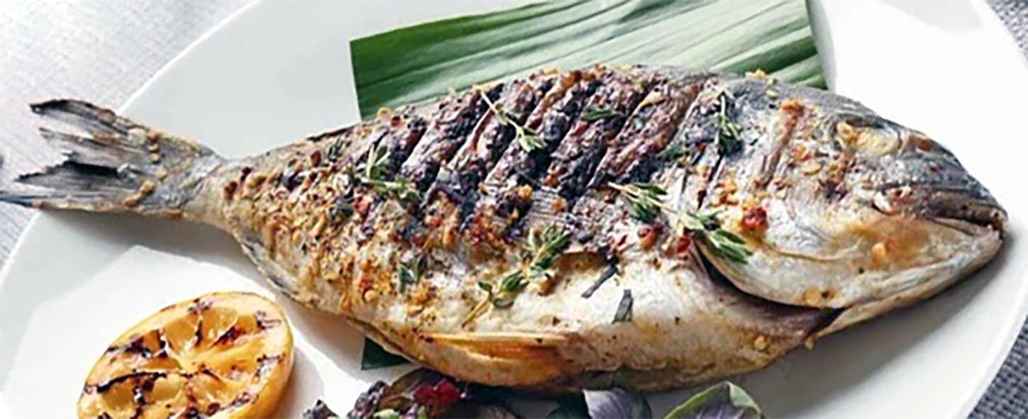 whole barbecued fish served on a plate