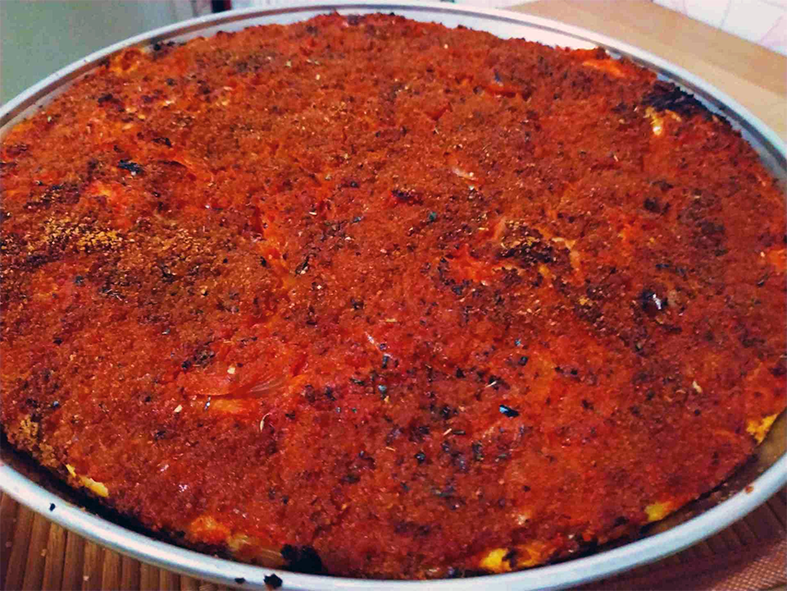 Palermo style pizza in a round metal base