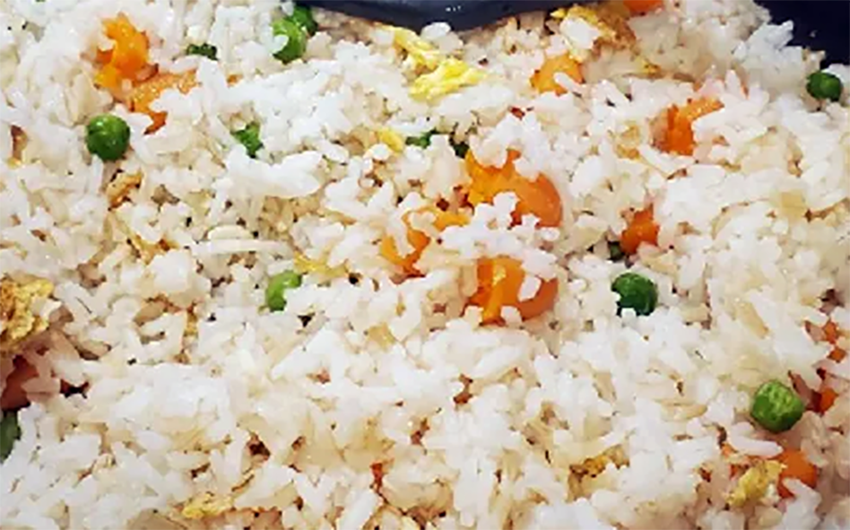 Simple fried rice with bacon, carrot, shallots, eggs and frozen peas with soy sauce