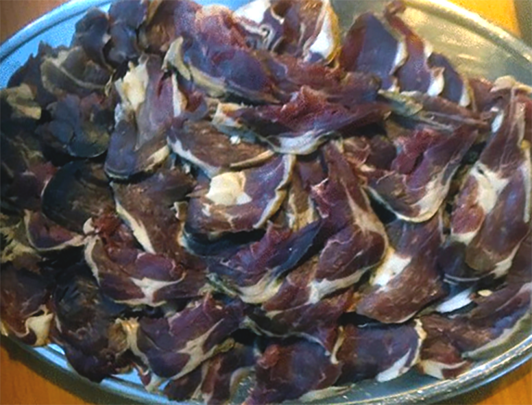 Skerpikjøt dried Faroese style dried mutton leg pieces piled on a steel tray