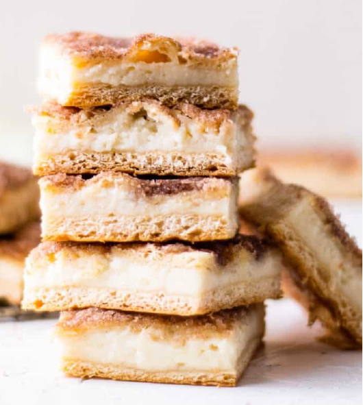 squares of sopapilla cheesecake piled five high