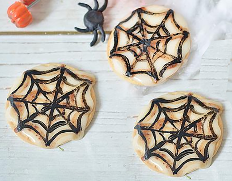 butter cookies decorated with a spiderweb pattern