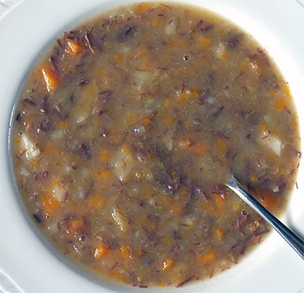 Skerpikjøt Soup in a white soup bowl with a spoon