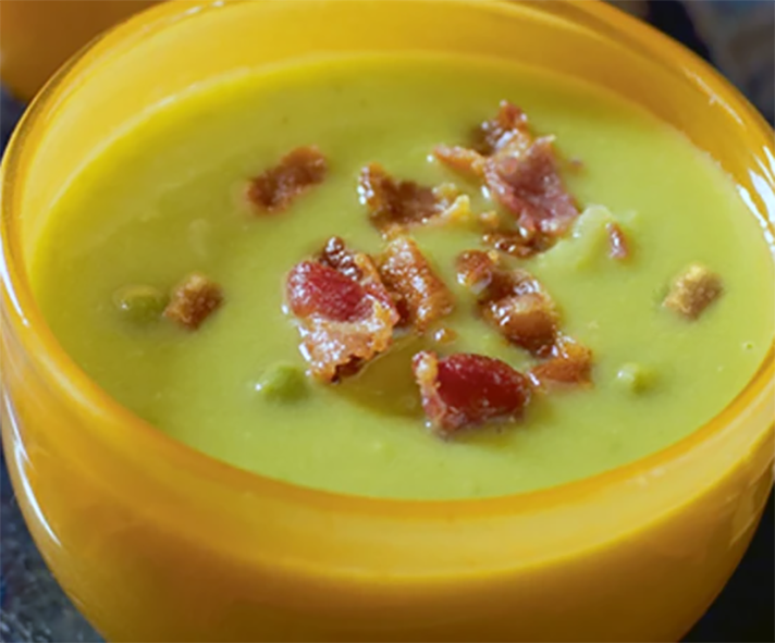 green soup with bacon scabs served in a glass