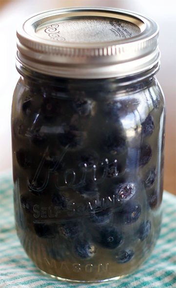 Sweet pickled bilberries in sweetened vinegar in a sealed jar