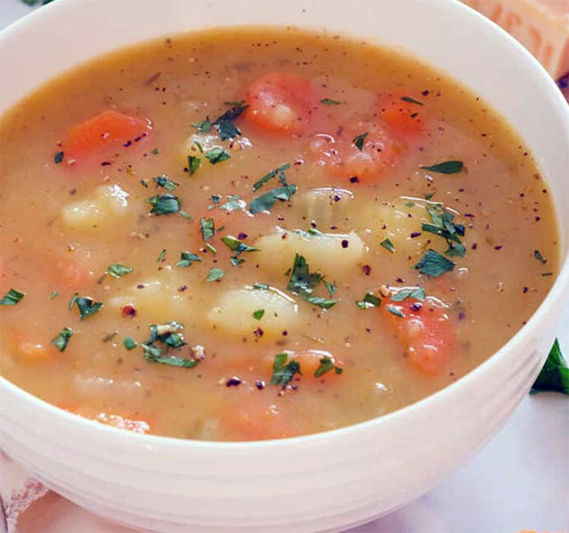Swiss soup of potatoes and carrots thickened with oats served in a white bowl