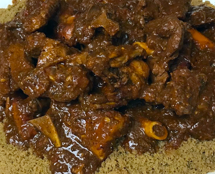 senegalese thiere bassy of mutton served on a bed of millet couscous