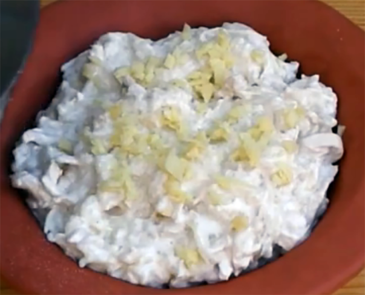 chicken blancmange in an earthenware dish garnished with chopped ginger