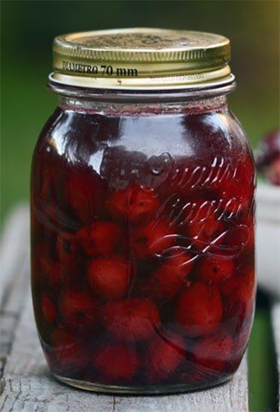 cherries preserved in syrup in a jar