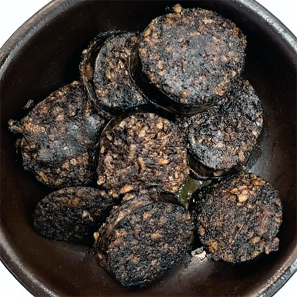 Fried slices of black pudding in a bowl