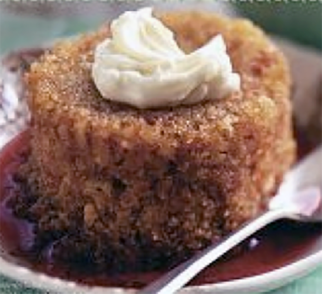 steamed honey oatmeal pudding from Ulster turned out on a plate and served garnished with cream