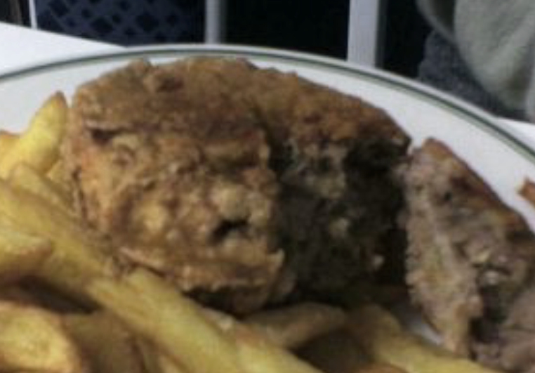 Fried ulster pastie with chips on a plate