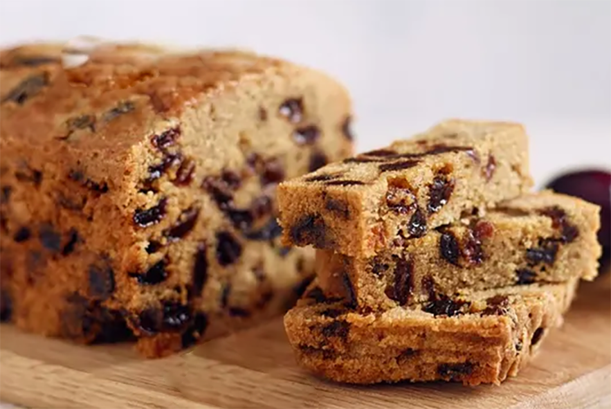 Irish vicarage tea-time fruit cake sliced on a wooden chopping board