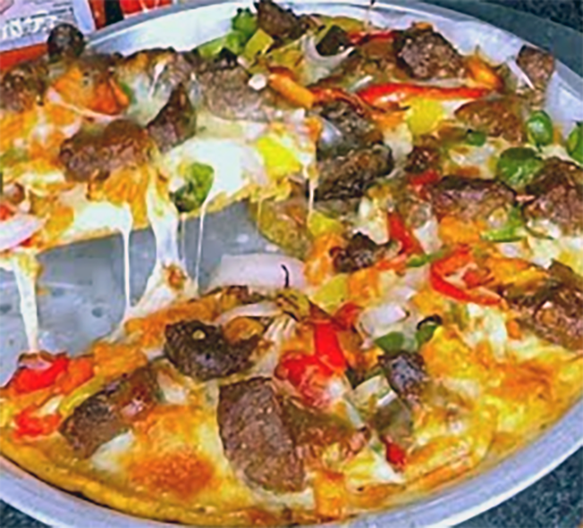 pizza topped with beef, fish, plantains and hot chillies