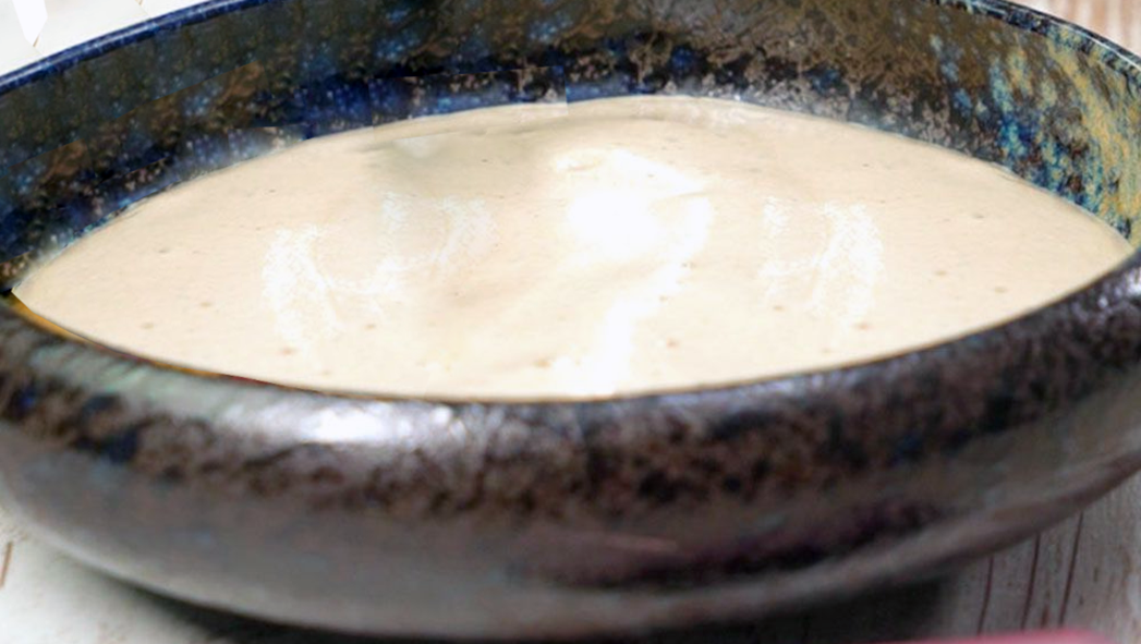white foam soup served in a granite bowl