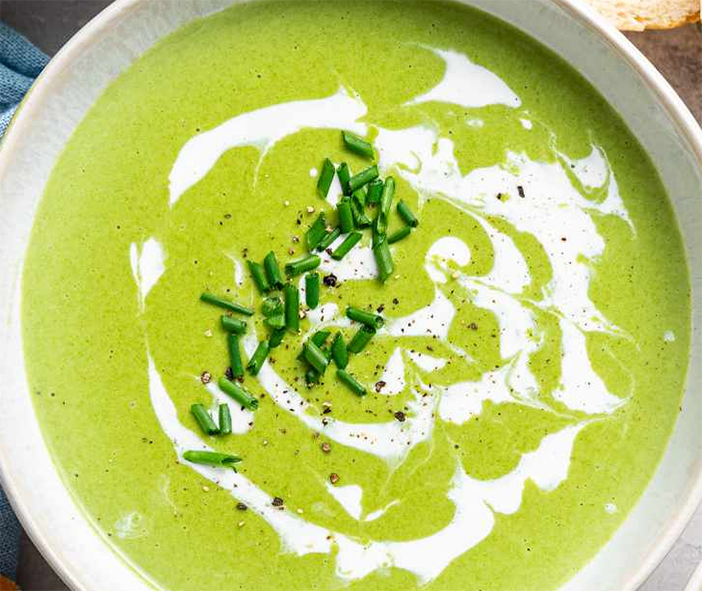 cream of wild greens soup served with a cream and chopped chive garnish