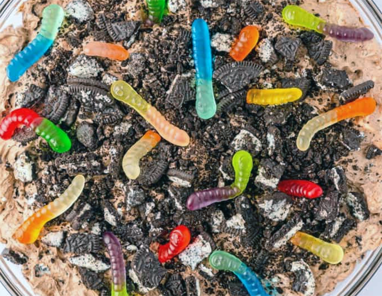 gummy worms in the dirt dessert served in a glass bowl