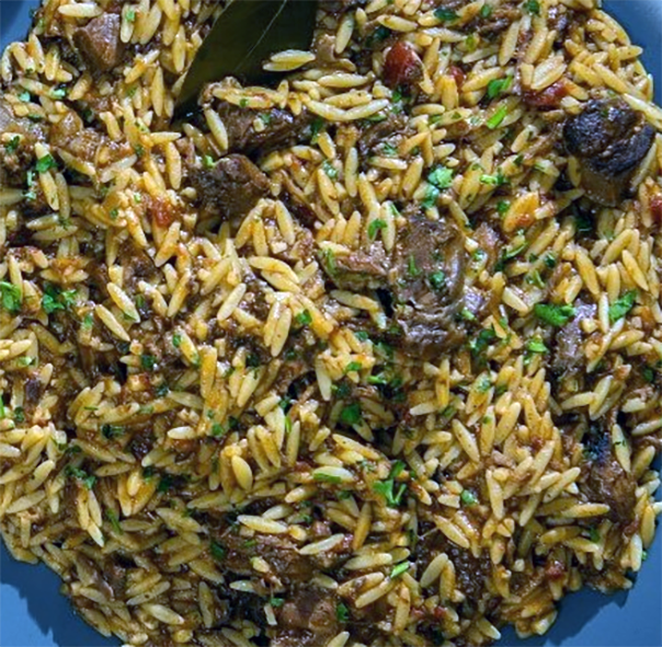 oven-baked orzo paste served topped with pieces of lamb