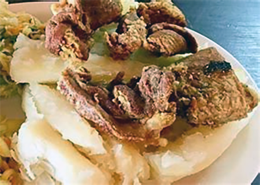 pork crackling served on a bed of boiled cassava