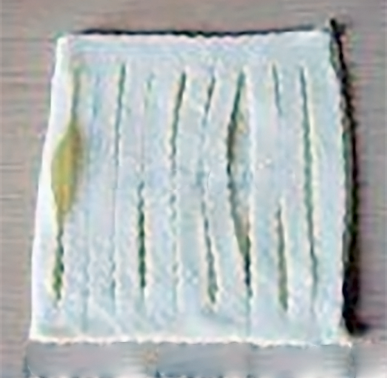 algerian tart pastry on a wooden table with slits cut along its length