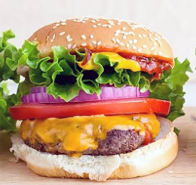 American cheeseburger with salad topping on a chopping board