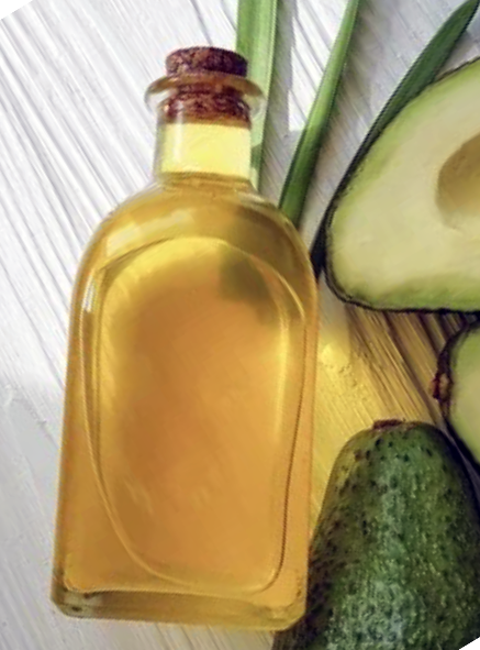 avocado leaf infused oil next to slivers of avocado leaves and halved avocados