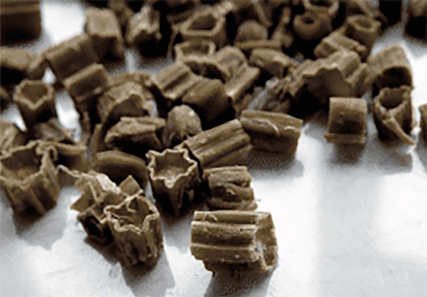 Candied bramble tip pieces on a metal work surface