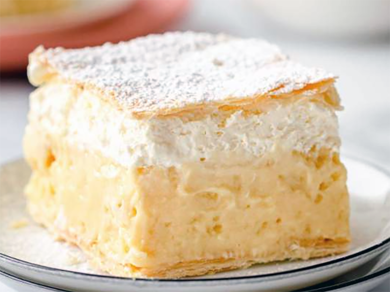 square of blejska kremšnita (cremeschnitte) served on a saucer