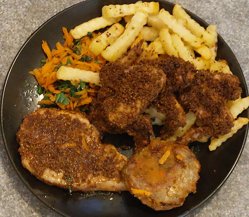 chicken wings and pork cutlet coated with suya spiced catkin crumbs, served with chips and a blend of grated carrot and shredded black mustard greens