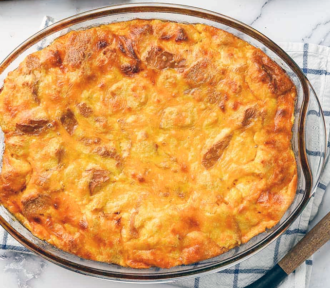 cheddar cheese bread pudding in a glass baking dish