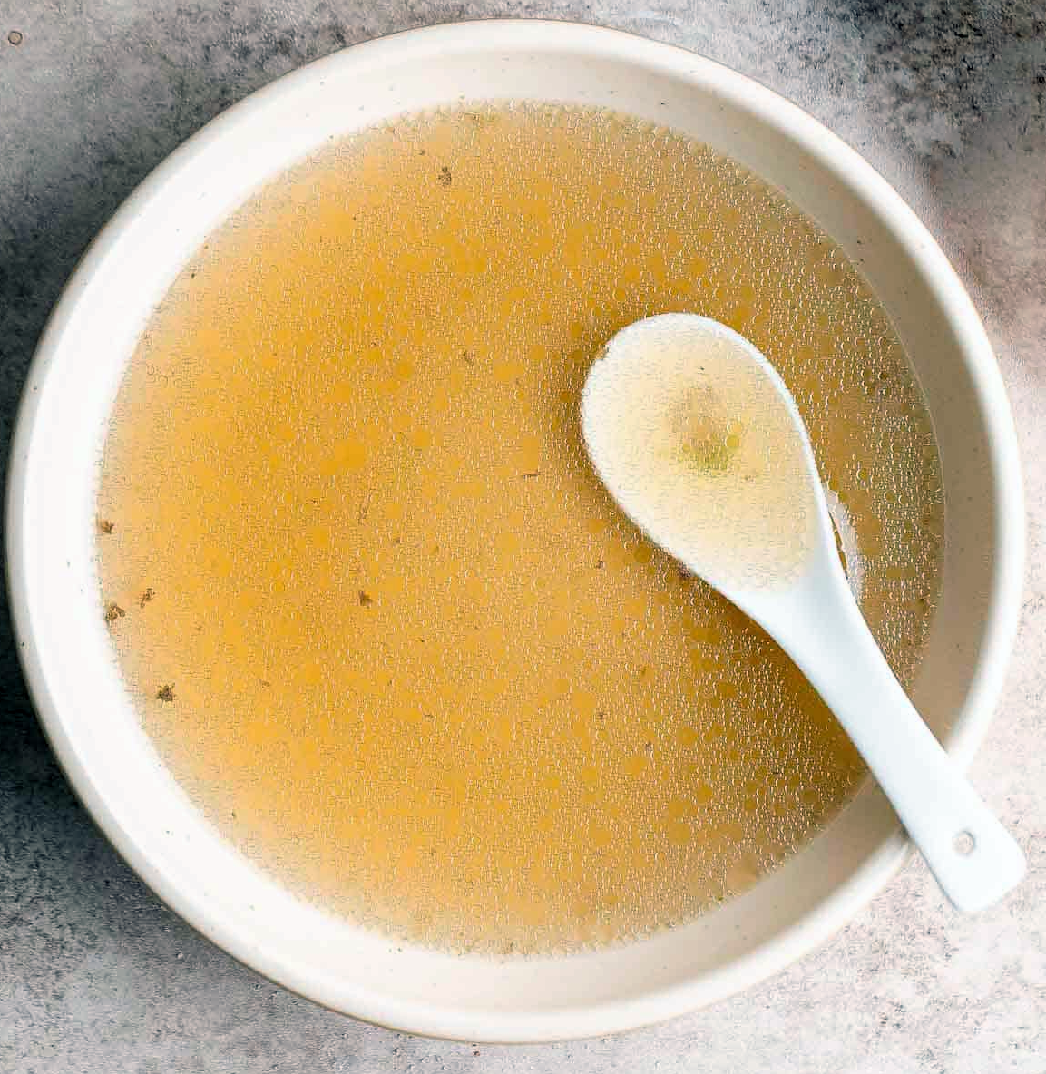 Chinese rib stock in a bowl with a porcelain spoon