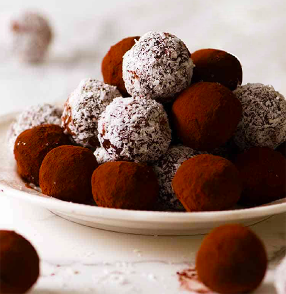 cocoa or icing sugar coated chocolate truffles piled on a plate