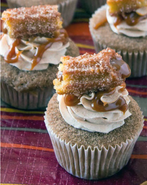 cinnamon-flavoured cupcakes topped with cinnamon buttercream, dulce de leche and churro pieces for Cinco de Mayo