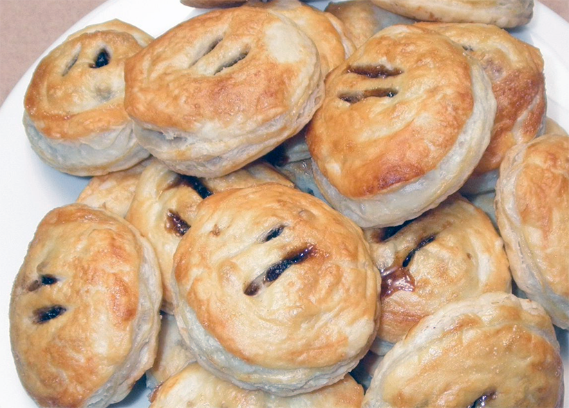 puff pastry eccles cakes piled on a plate