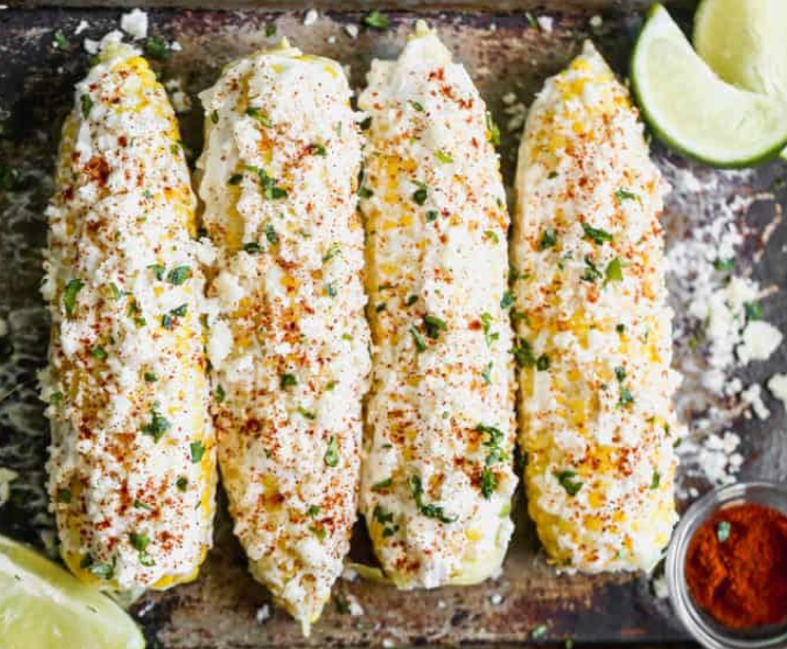 elote or mexican street corn, four cobs in a baking dish